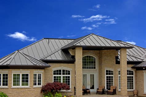 brick house with brown metal roof|matching brick and roof colors.